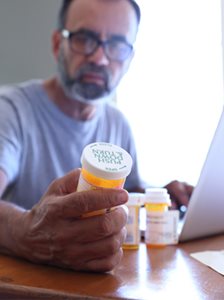 HealthSmartRx person reading pill bottle